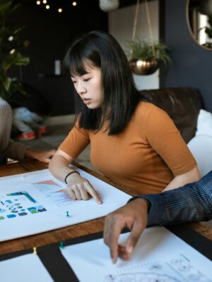 Young woman engaged in work at a creative office space with design documents.